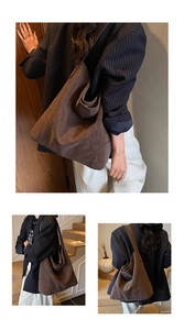 Detailed close-up showing the matte leather texture and drape of this brown tote bag