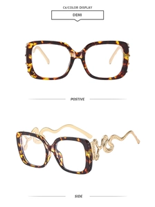 Detailed view of tortoiseshell square glasses with gold snake metal temples and engraving