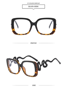 Detail of square glasses frame with unique snake-shaped temples in black and demi finish