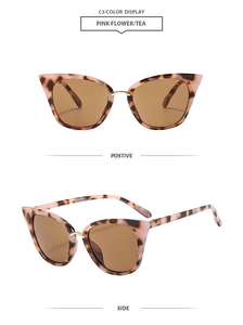 Detail of pink floral cat eye sunglasses with golden bridge and brown lenses