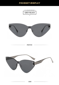 Details einer rahmenlosen Cat-Eye-Sonnenbrille mit grauen Gläsern und Nieten