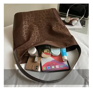 Spacious leopard print tote bag interior showing storage for tablet and cosmetics