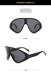 Détail des lunettes de soleil oversize avec logo FASHION en relief sur les branches