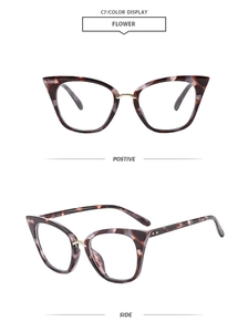 Detail view of retro cat-eye sunglasses with tortoiseshell frame and gold metal bridge