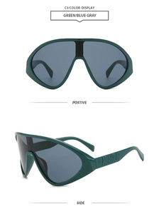Détail de lunettes de soleil vertes oversize avec lettrage Fashion en relief sur la branche