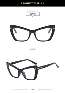 Detail of black cat-eye glasses frame featuring a distinct gold T-shaped metal hinge inlay