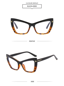 Detail of cat eye glasses frame in black and demi with signature metal T decoration