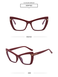Macro detail of wine red cat eye glasses frame with gold T-shaped metal accents