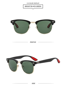 Close-up of classic round frame sunglasses with green lenses and gold metal details
