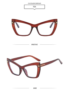 Detail of cat-eye glasses frame featuring a golden T-shaped metal hinge and tea color finish
