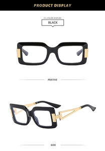 Detail view of square black frame glasses with golden hollowed metal temples and design