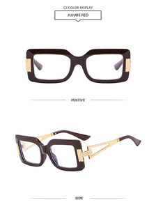 Detail of square jujube red eyeglasses with unique hollowed golden metal temples