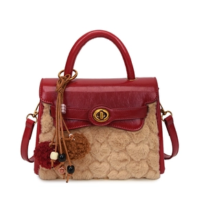 Red and beige plush handbag with heart texture, rotating metal clasp and charm