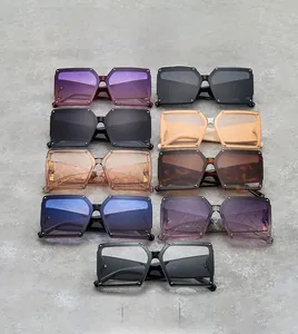 Flat lay of square oversized sunglasses in nine colors with rivet details on grey texture