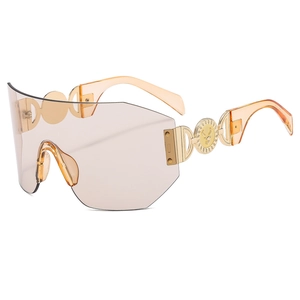 Lunettes de soleil ambre sans monture avec branches dorées ajourées et décor de cerf
