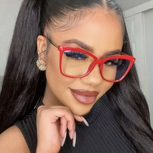 Detail of red cat-eye glasses frame with metallic temples shown on a model