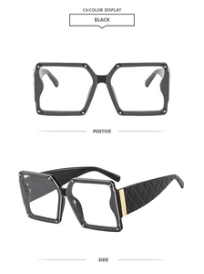Detail of black square frames with silver studs and black quilted leather temples