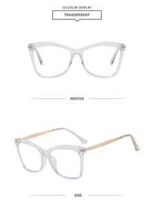 Close-up of retro cat-eye glasses with transparent frames and gold metal temples