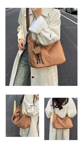 Detail view of brown suede hobo bag featuring decorative stitching and cute bear charm