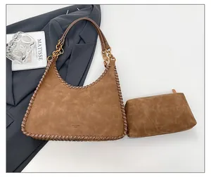 Detail view of brown suede shoulder bag featuring woven edges and a matching inner zipper pouch