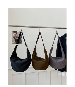 Detailed comparison of three canvas half-moon bags in black, olive green, and dark gray