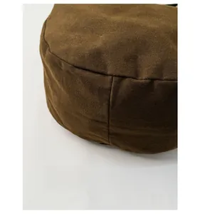 Close-up of wide base design on high-capacity canvas shoulder bag in dark olive green