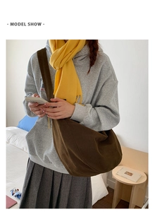 Brown canvas dumpling bag styled with oversized hoodie and scarf for a casual look