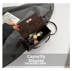 Internal view of dark brown matte Kelly bag showing capacity for phone and cosmetics