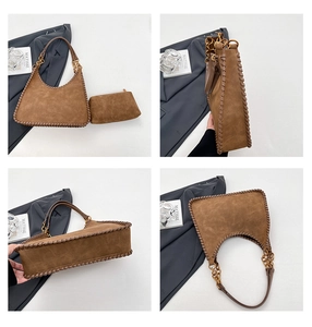 Detail view of vintage brown suede hobo bag with woven edges and gold chain strap