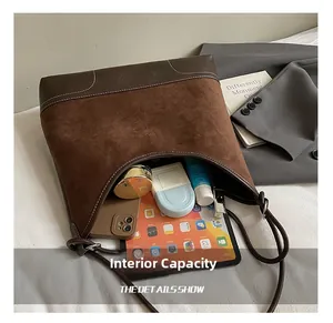 Detailed view of the large capacity interior of this matte brown faux suede tote bag