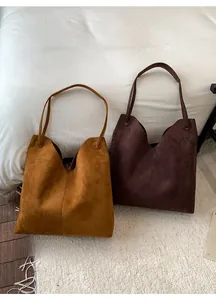 Vue détaillée de grands sacs cabas en daim caramel et café avec design en V