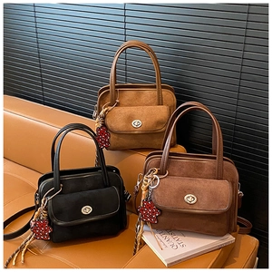 Detailed view of vintage texture handbags with metallic twist locks and cute charms
