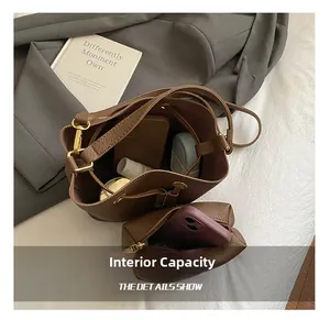 Top view of brown leather bucket bag set showing spacious interior with personal essentials