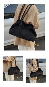 Detail of black large capacity faux suede tote bag showing soft texture and shoulder straps