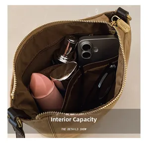 Internal compartments of the brown suede bucket bag showing large capacity for essentials