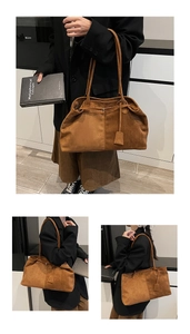 Detail of caramel suede tote bag featuring side pleats and slim shoulder straps