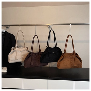 Detail of four matte suede tote bags in beige, dark coffee, black, and caramel colors
