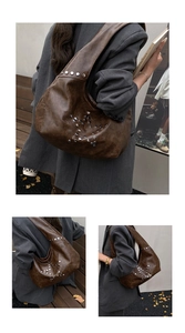 Close-up of star-shaped silver rivet patterns on brown leather retro shoulder bag