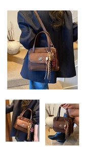 Detail of vintage brown bowling bag featuring a metal clasp and a bear charm pendant