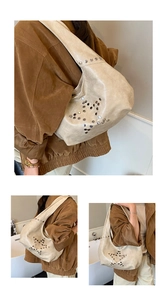 Macro detail of beige hobo bag with star-shaped silver rivet patterns and matte texture