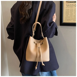 Detail of lychee pattern bucket bag with adjustable straps and drawstring closure