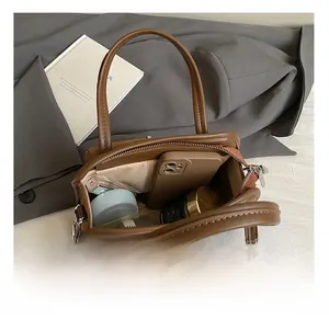 Top view of spacious brown handbag interior showing large capacity for daily items