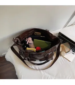 Top view of spacious interior storage of brown faux leather tote bag with daily items