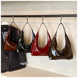Row of minimalist vintage hobo bags in dark brown, black, burgundy, and chocolate