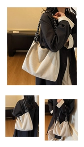 Detail of off-white corduroy tote with textured vertical stripes and woven checkered strap