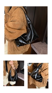 Detail of a large black glossy patent leather hobo bag with sleek mirror finish straps