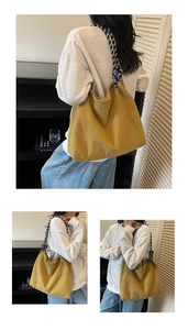 Detail of mustard yellow pleated knit tote bag featuring a black and white woven strap