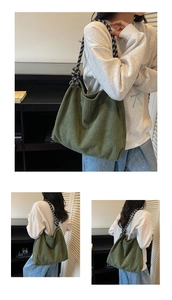 Detail of dark green corduroy tote bag with black and white checkered woven strap