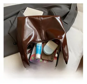 Interior view of vintage brown tote bag showing large capacity for iPad and cosmetics