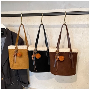 Three lamb wool trim bucket bags in yellow, black, and brown with cute charms